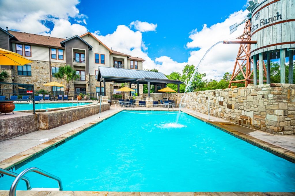 Exterior shot of Austin, TX affordable housing complex and swimming pool.